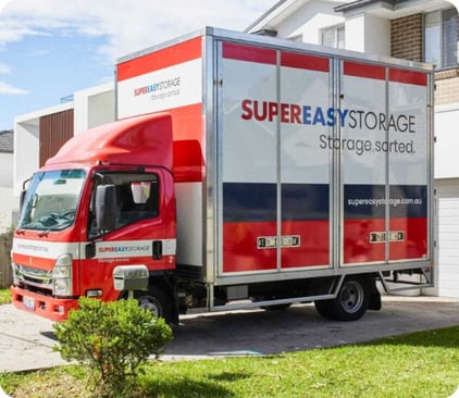 Couple beside moving boxes and a pet carrier