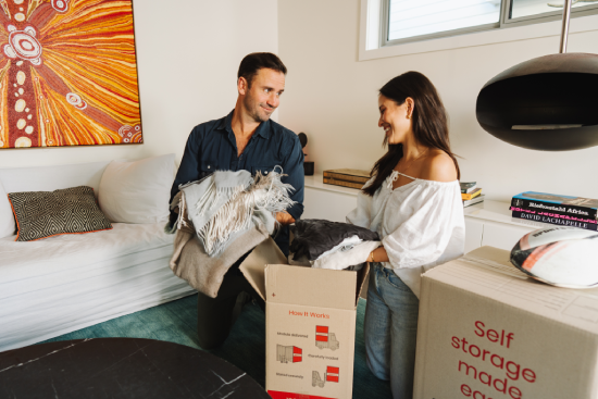 Couple unpacking boxes during a move